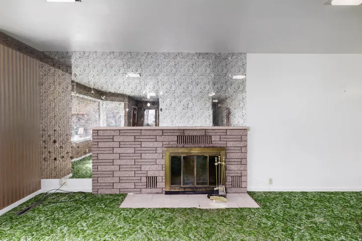 Detailed view of a stone fireplace and carpet