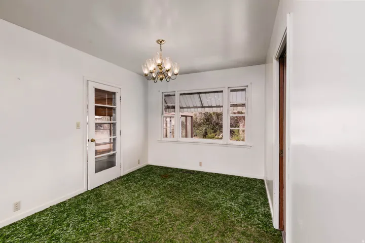 Unfurnished dining area with carpet flooring and hanging lights