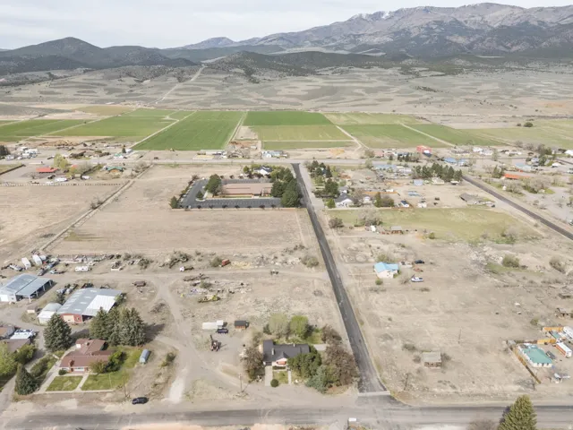 Aerial view of property and surrounding area with rural landscape and mountains