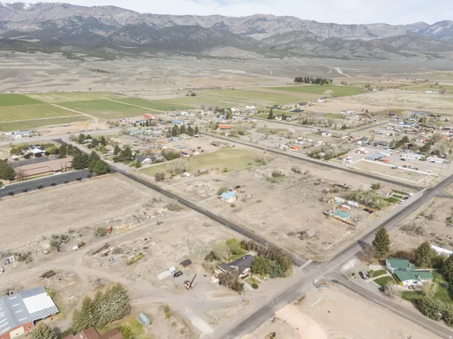Aerial overview of property's location with a mountain backdrop and rural landscape