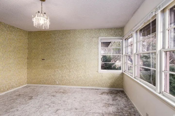 Unfurnished sunroom featuring suspended lighting