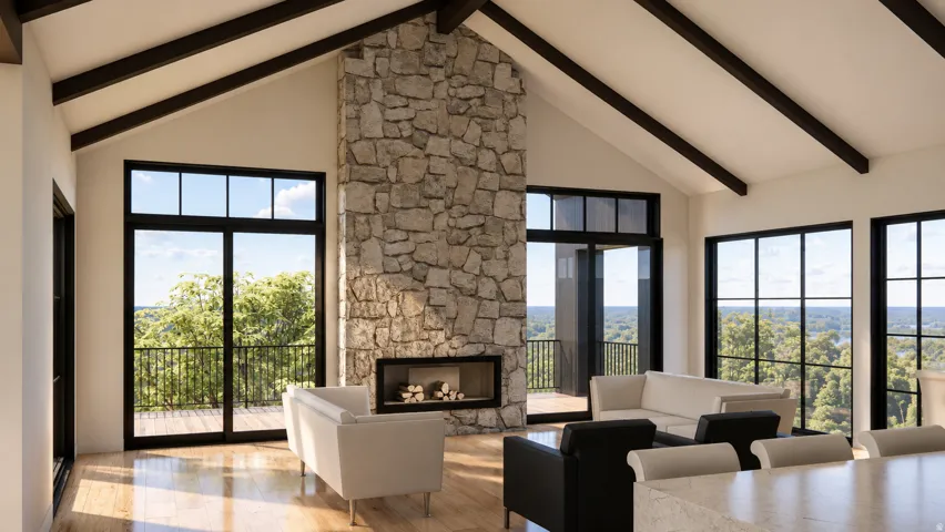 Vaulted ceiling with exposed beams, stone fireplace with a built-in hearth, large format windows with black frames, wood-finish flooring, and a glass-paneled sliding door opening to an outdoor railing