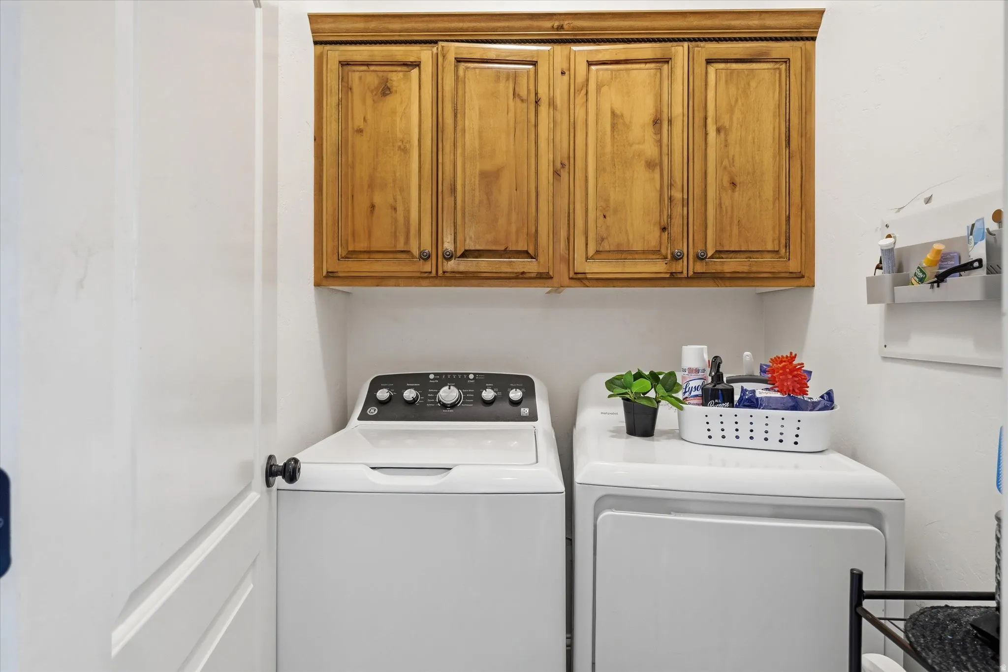 Laundry area with washing machine and clothes dryer and cabinet space