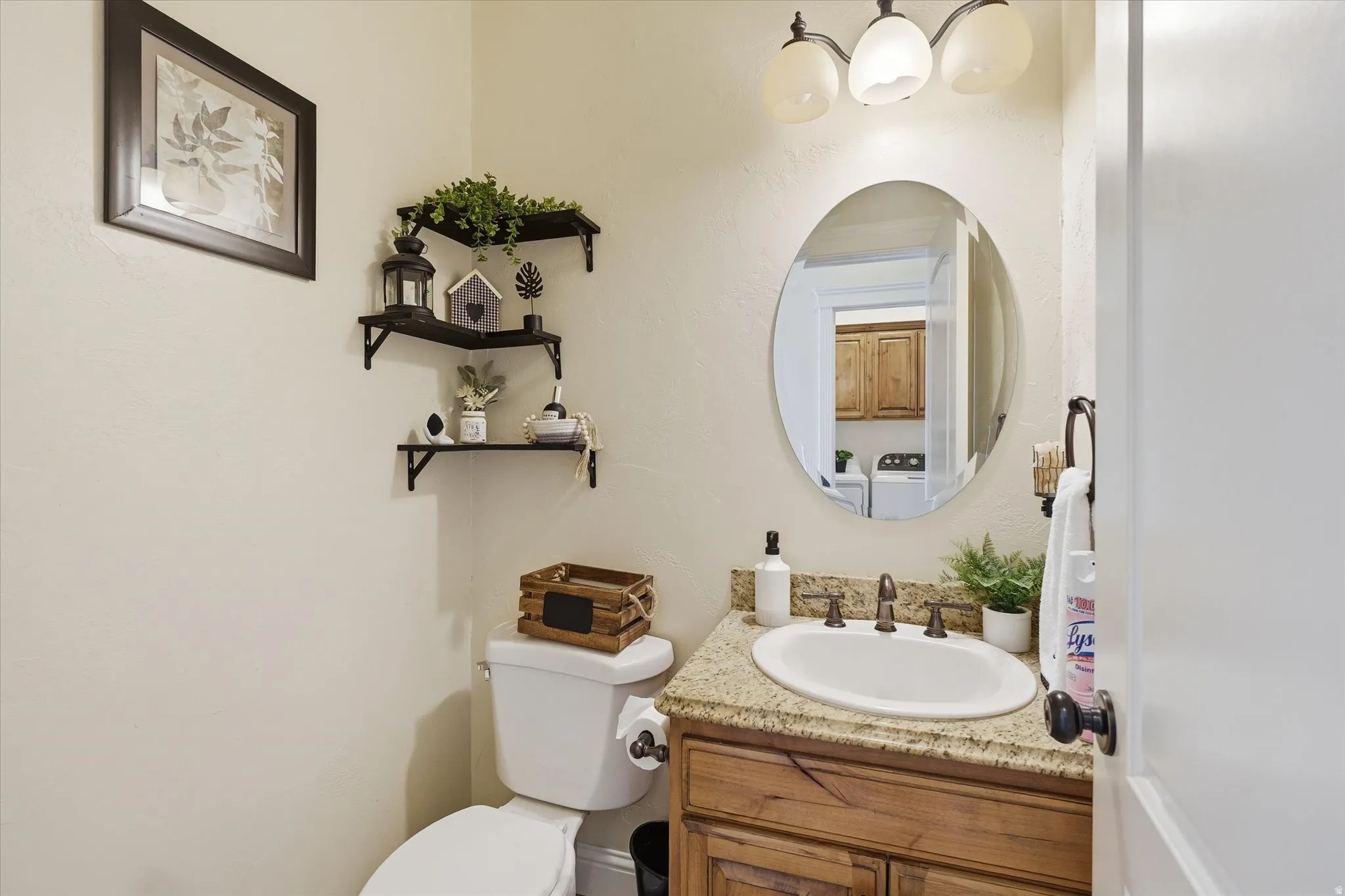 Half bathroom featuring vanity and toilet