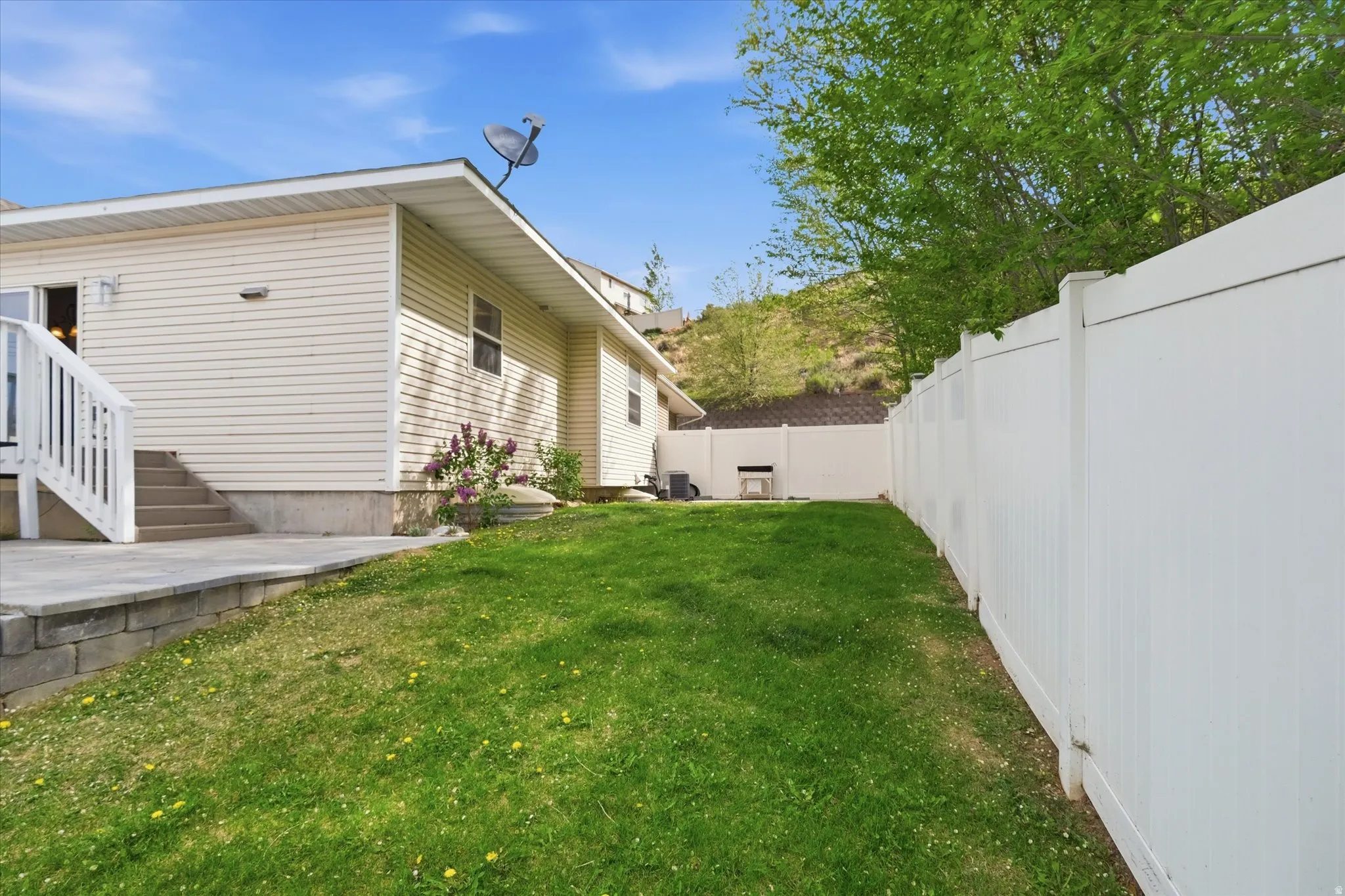 View of side of home featuring a fenced backyard