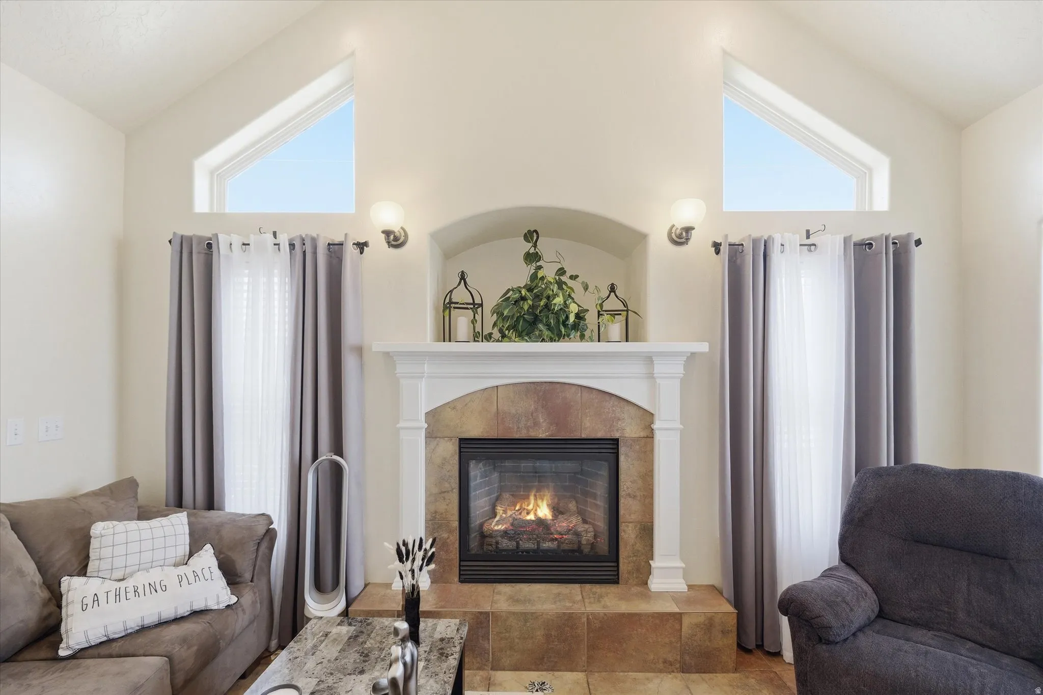 Living area with vaulted ceiling and a tile fireplace