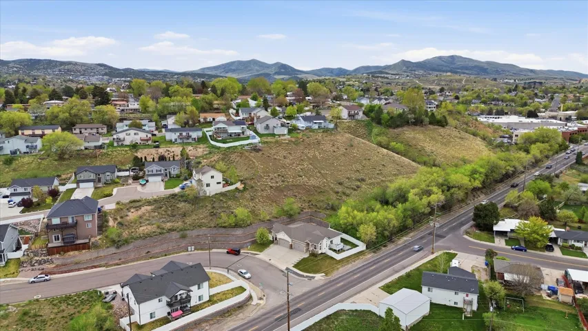 Aerial view of residential area featuring a mountainous background
