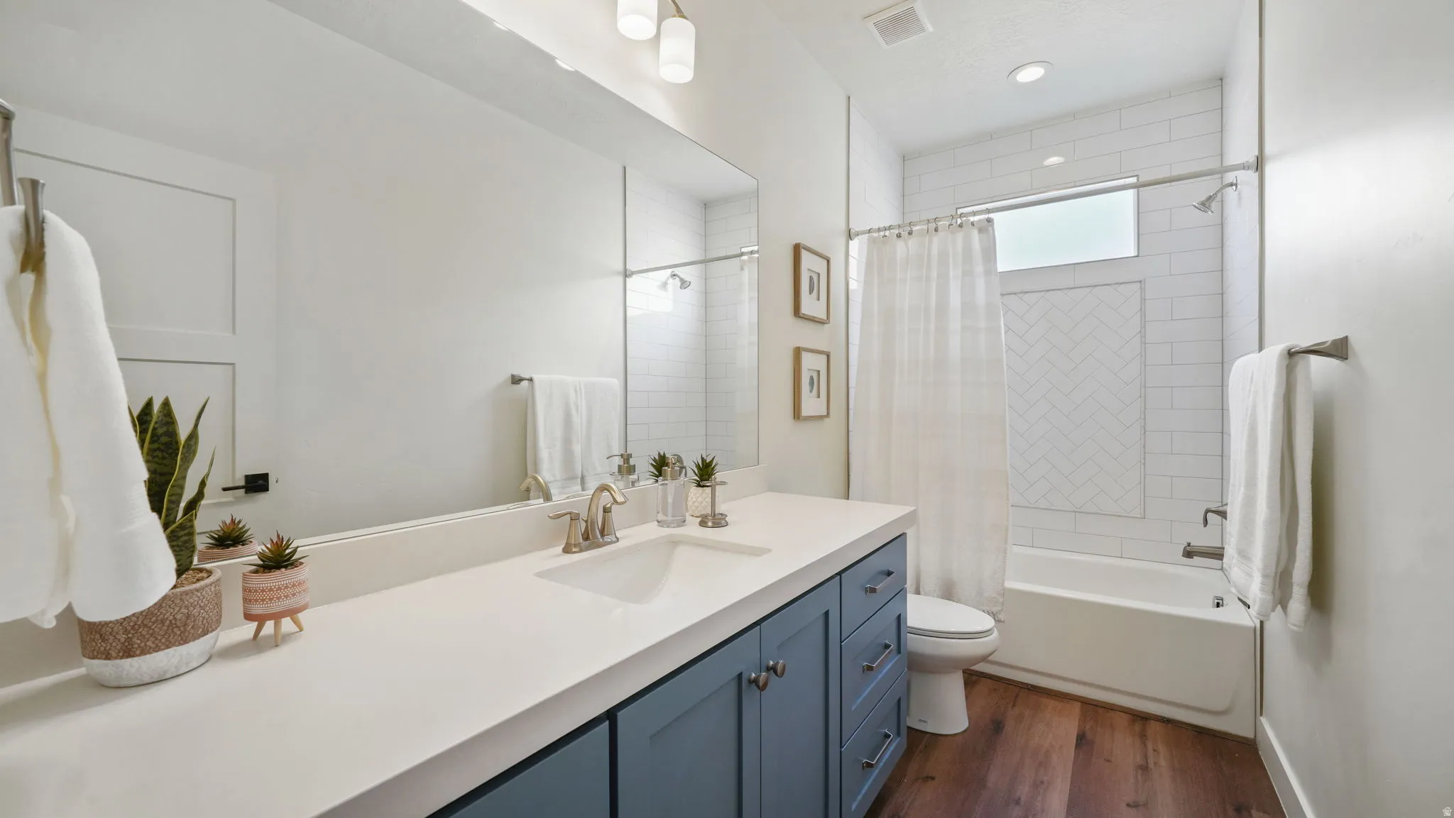 Full bathroom featuring vanity, shower / bath combo, and LVP floors