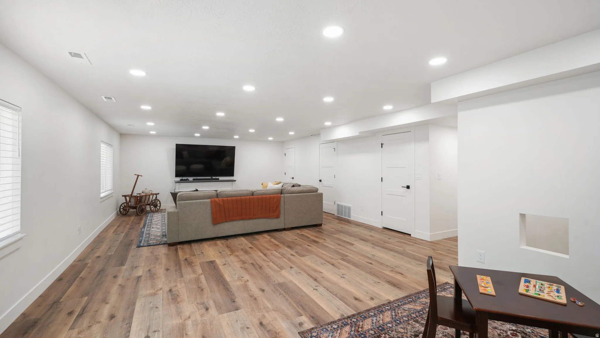 Family room featuring wood-style LVP flooring and recessed lighting