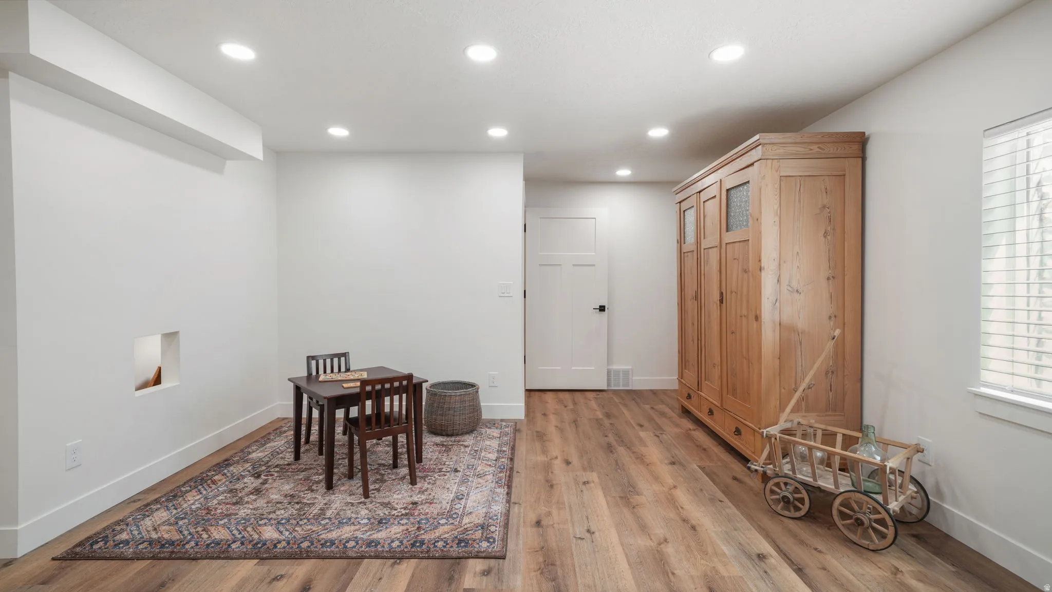 Dining room with light wood-style floors and recessed lighting