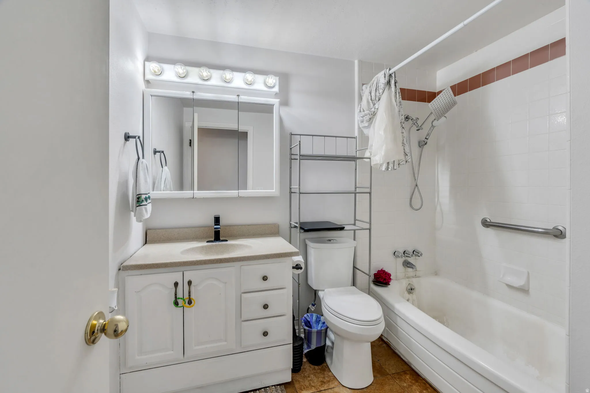 Full bathroom featuring vanity and shower / bath combination with curtain