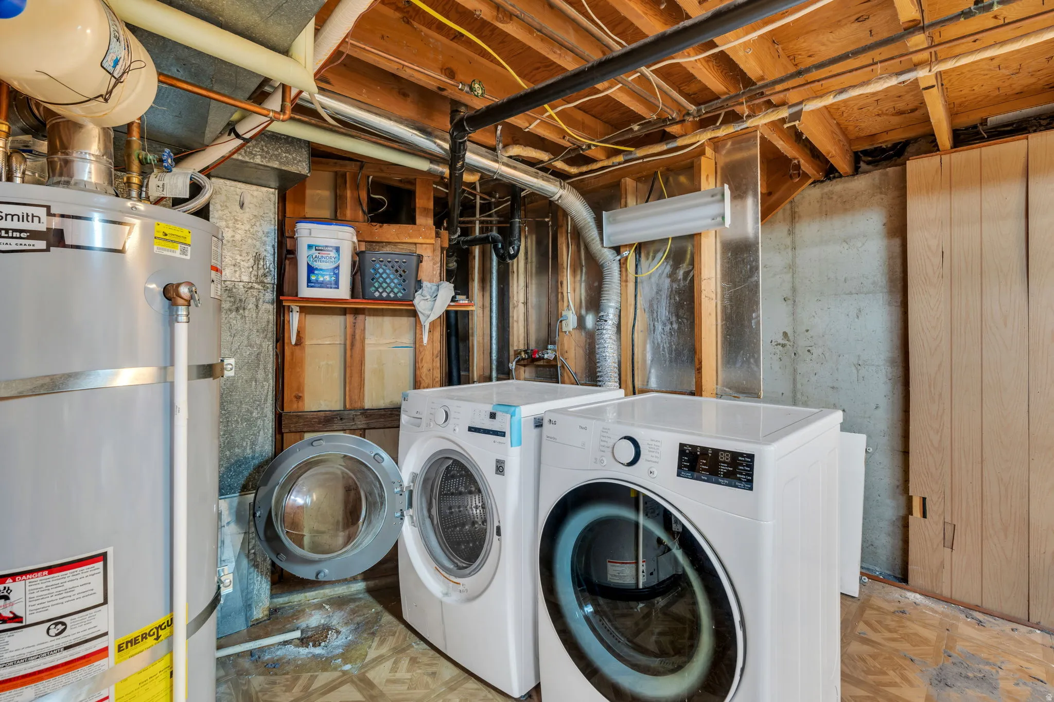 Laundry located in large unfinished storage room in basement