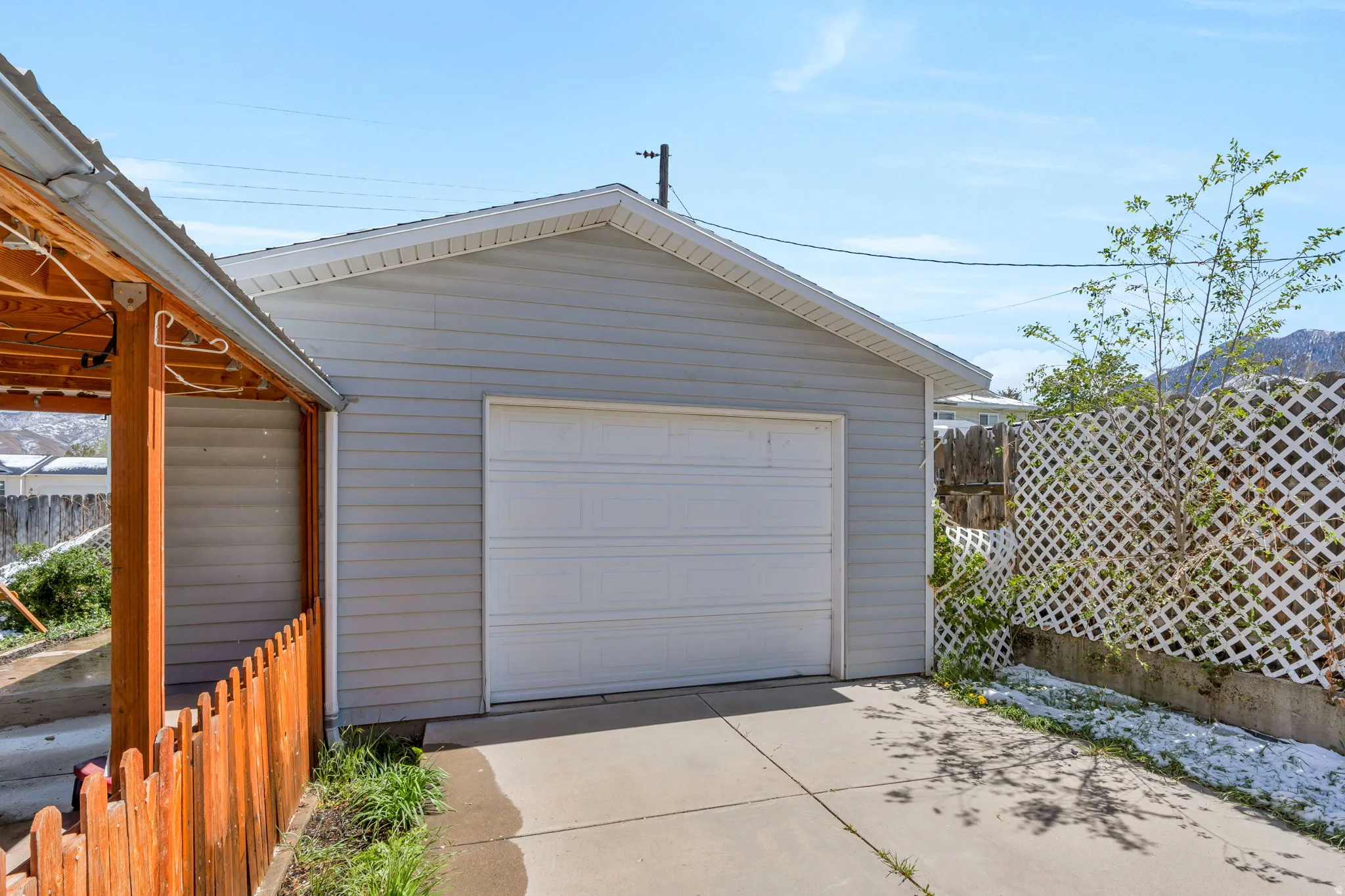 Detached garage with concrete driveway