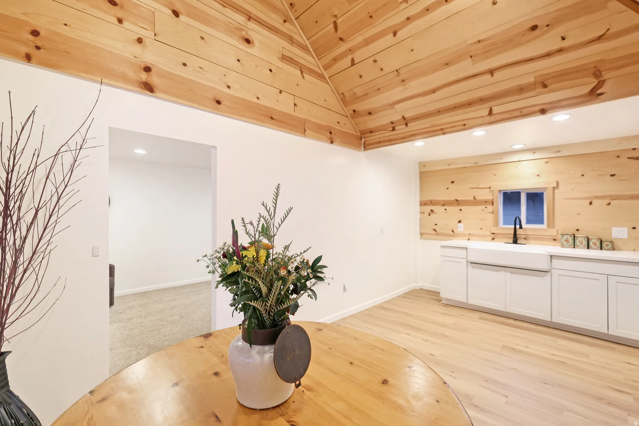 Dining space with recessed lighting, light wood-type flooring, wooden walls, and wooden ceiling