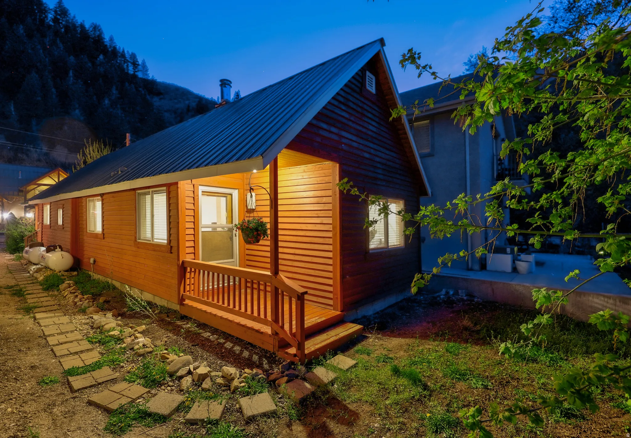 View of property exterior with a metal roof and a deck