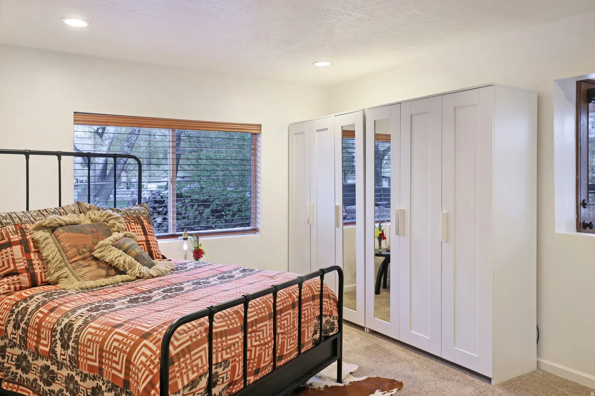 Bedroom with light colored carpet