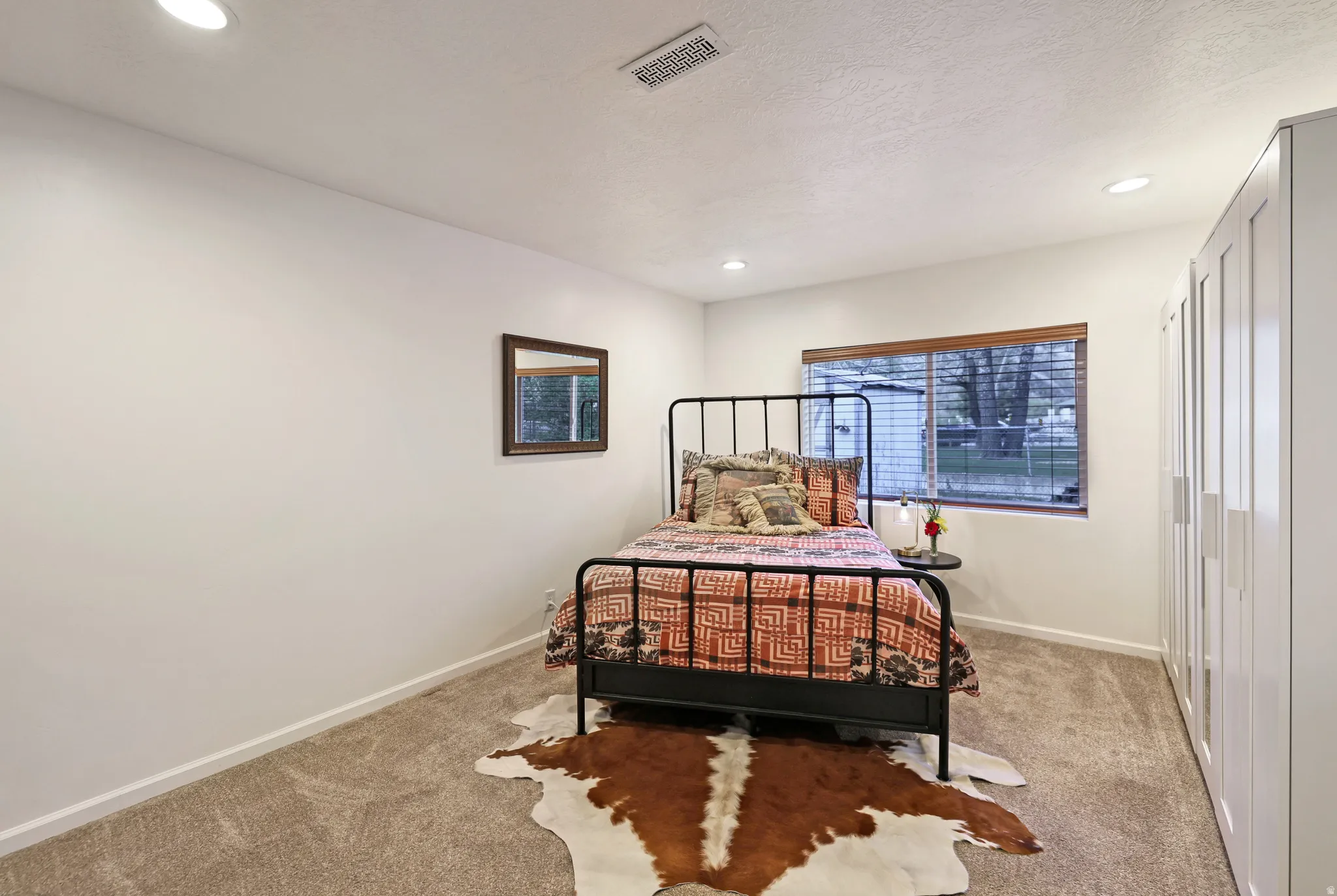 Bedroom with light carpet and recessed lighting