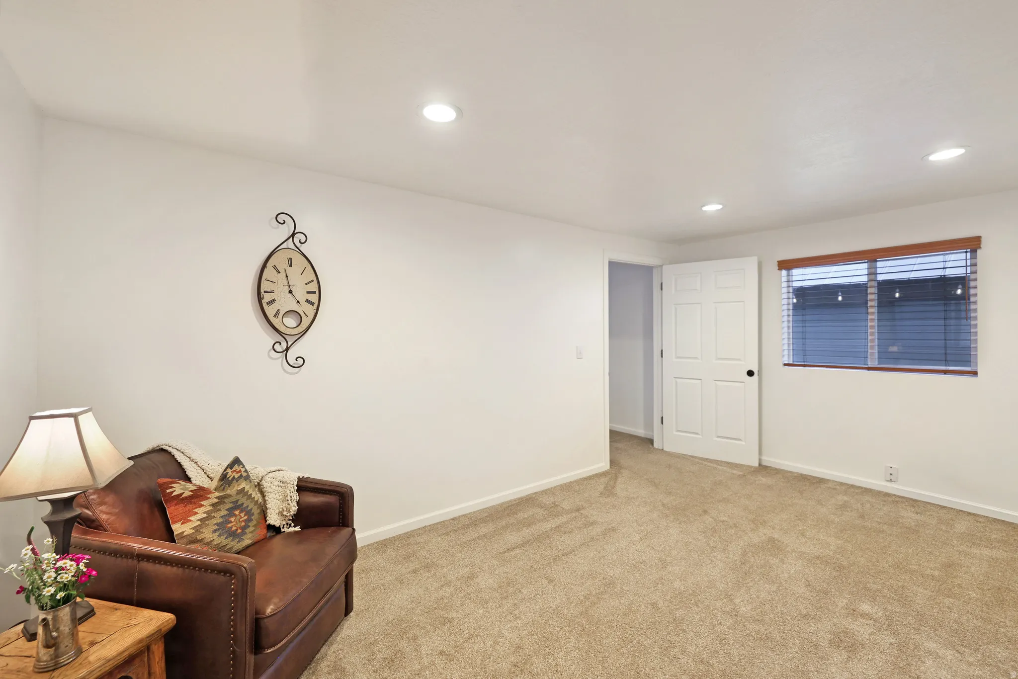 Living area with carpet flooring and recessed lighting