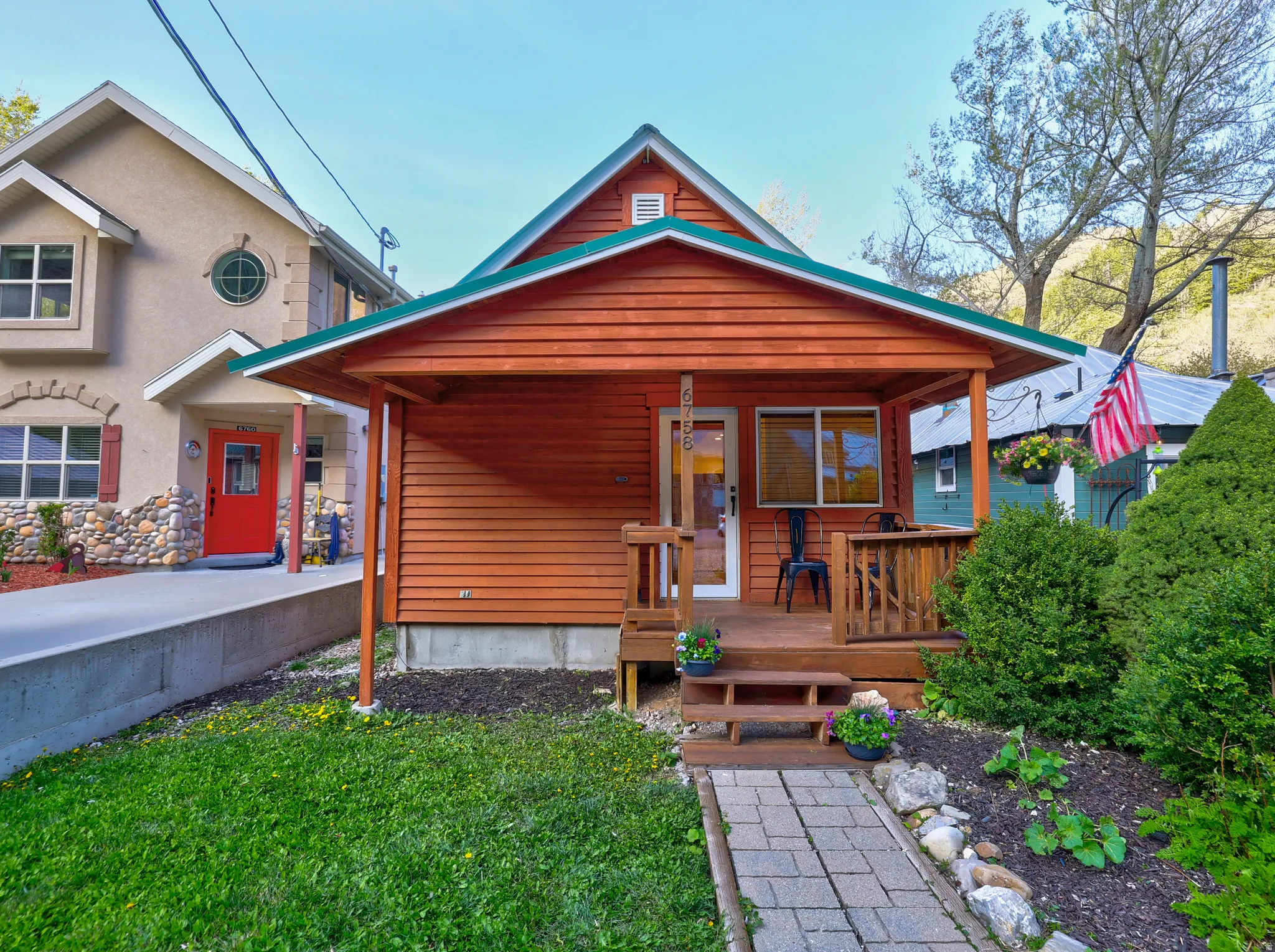 View of front of property with covered porch, a front lawn, and stucco siding