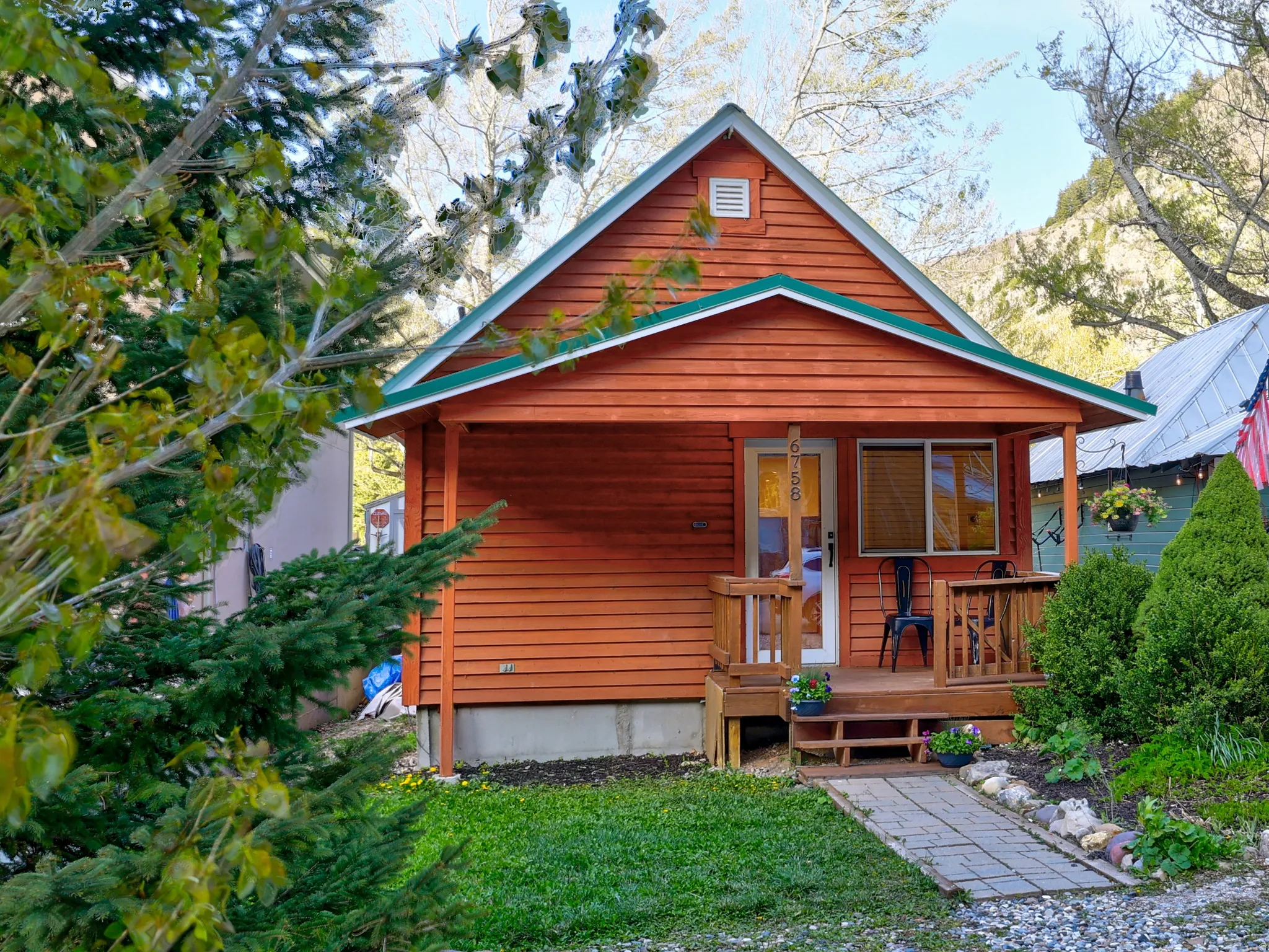 Rear view of property with covered porch