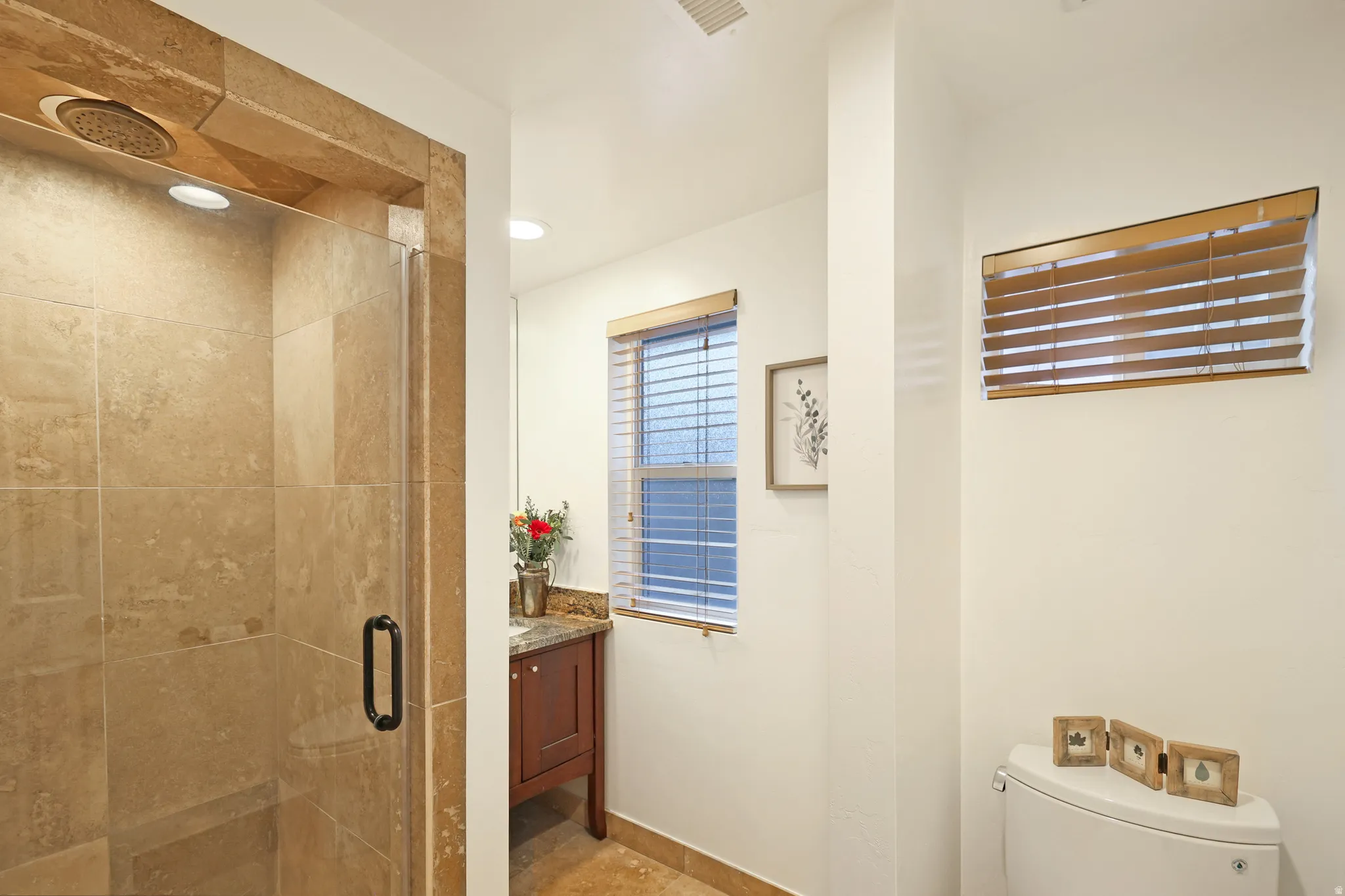 Bathroom with vanity and a stall shower