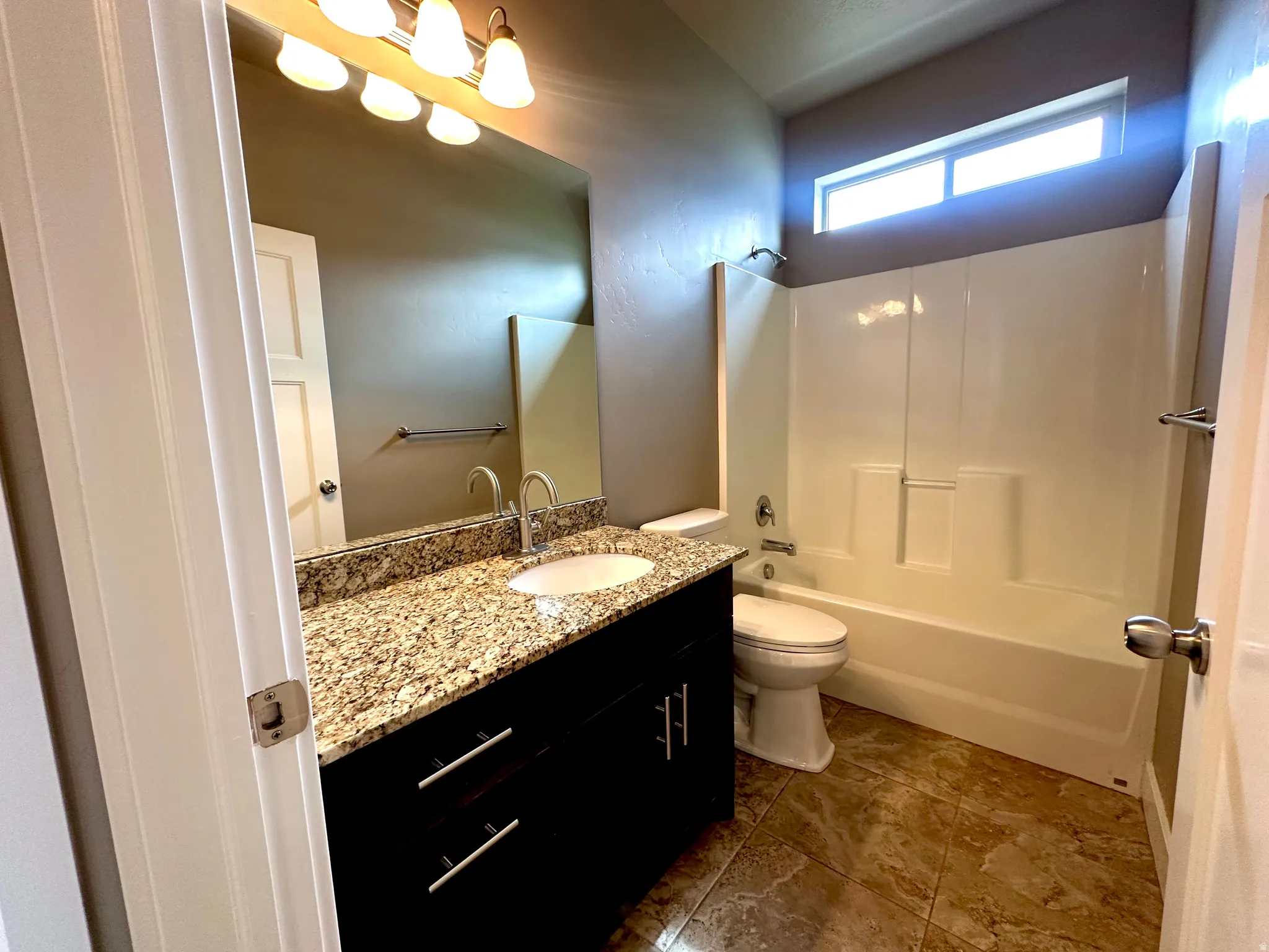 Full bath with vanity and tub / shower combination