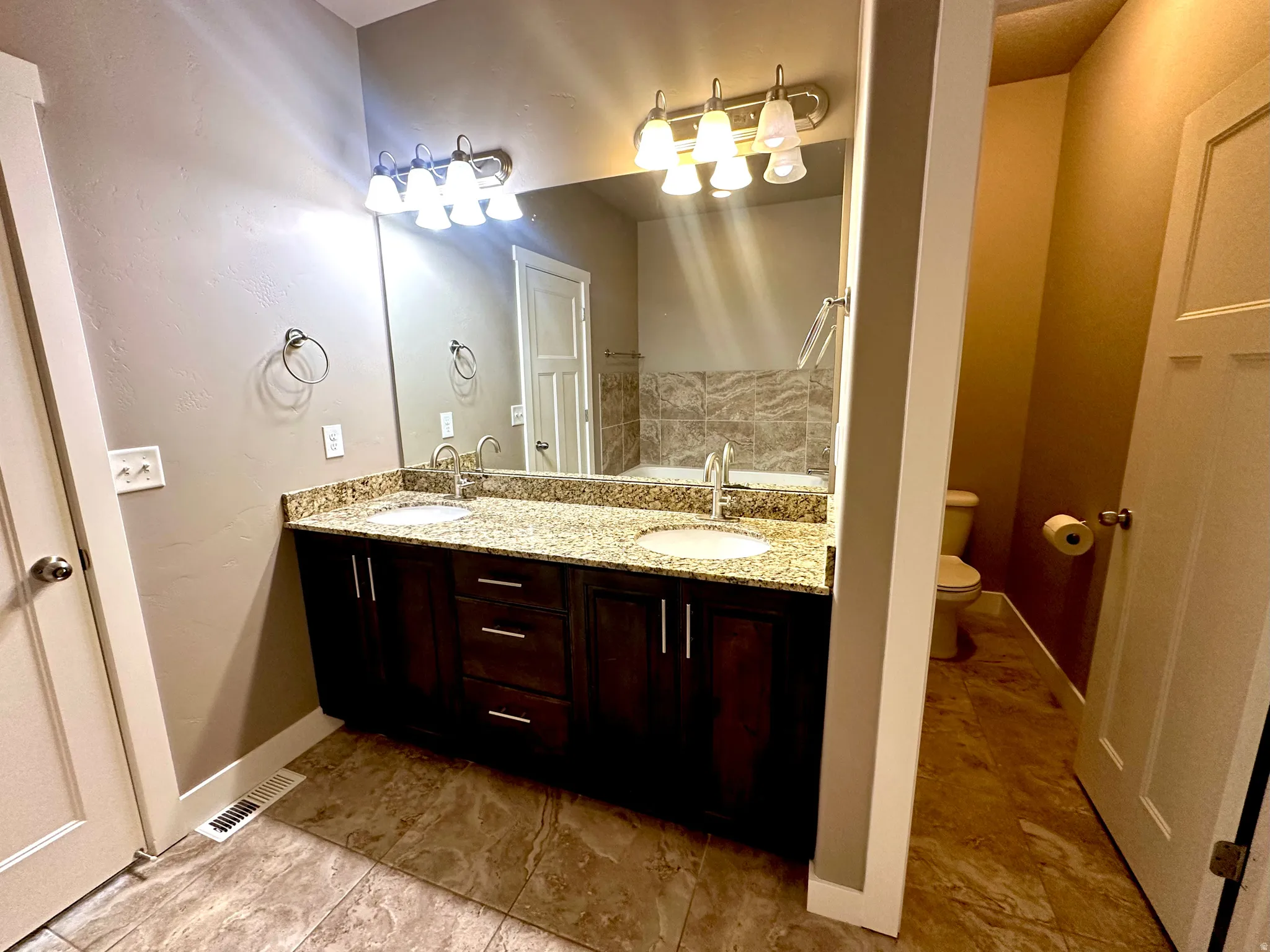 Full bathroom with double vanity and a garden tub