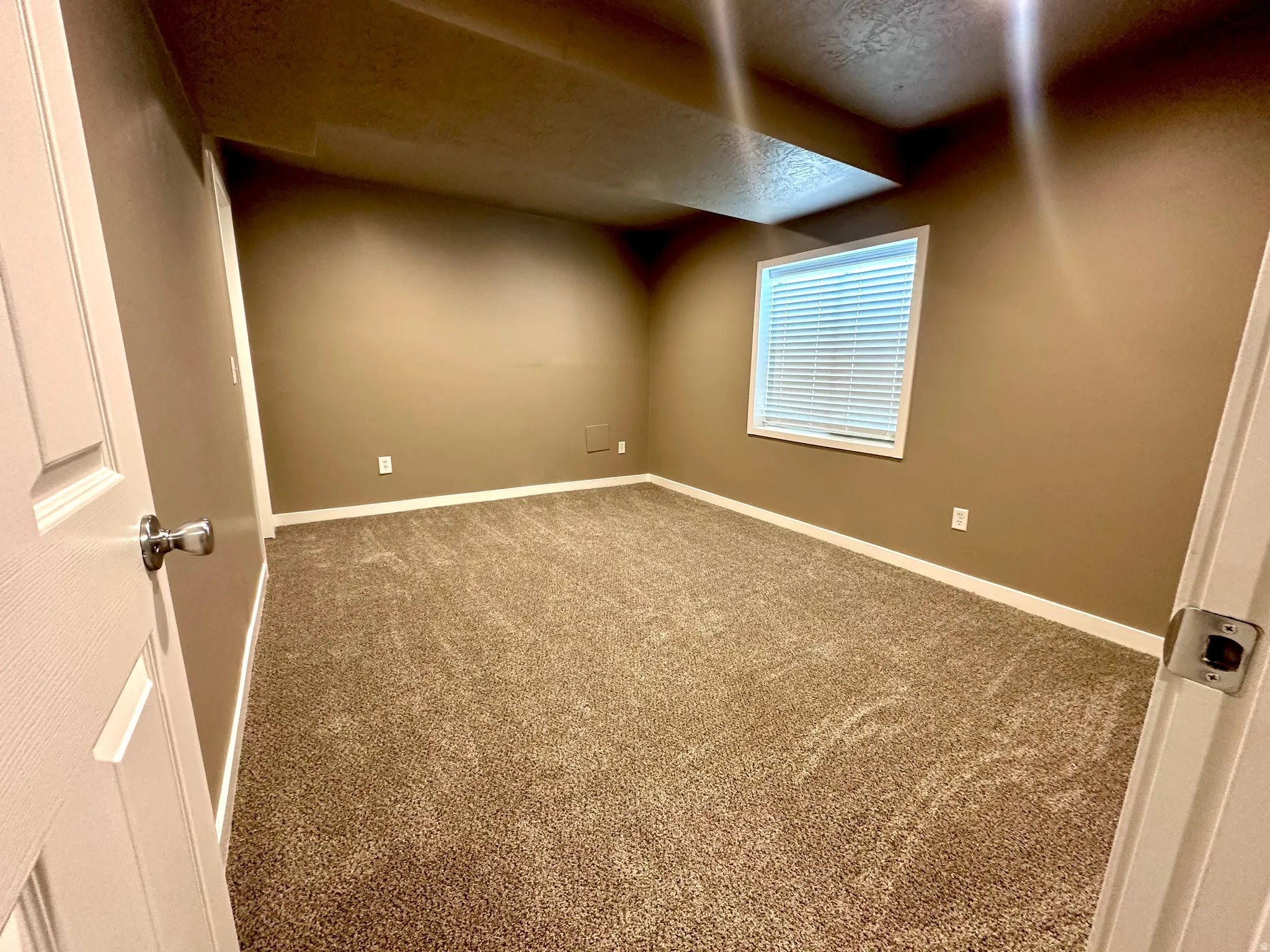 4th bedroom carpeted empty room featuring baseboards and a textured ceiling