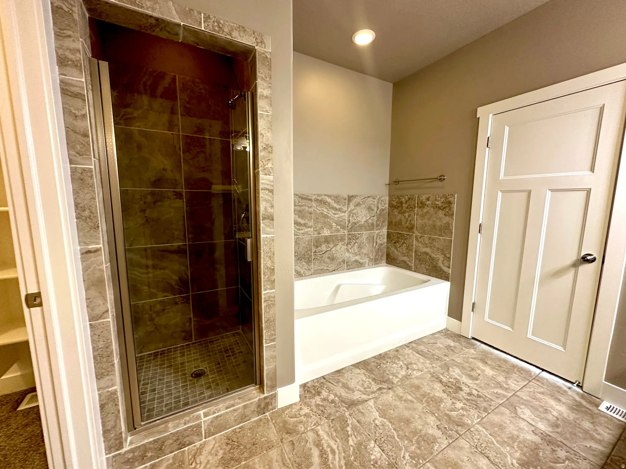 Bathroom with a bath, a shower stall, and recessed lighting