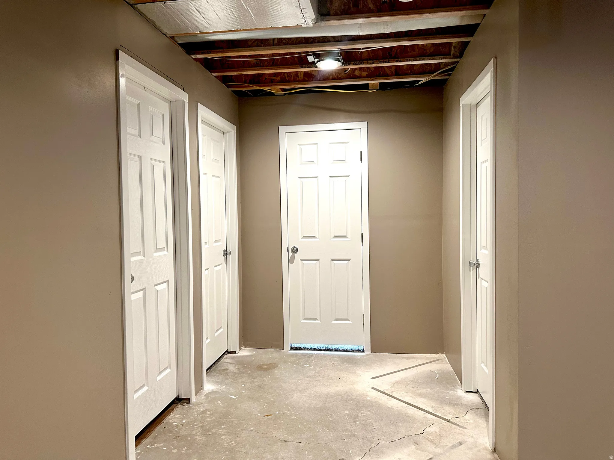 View of basement rooms, bathroom, and office hallway.