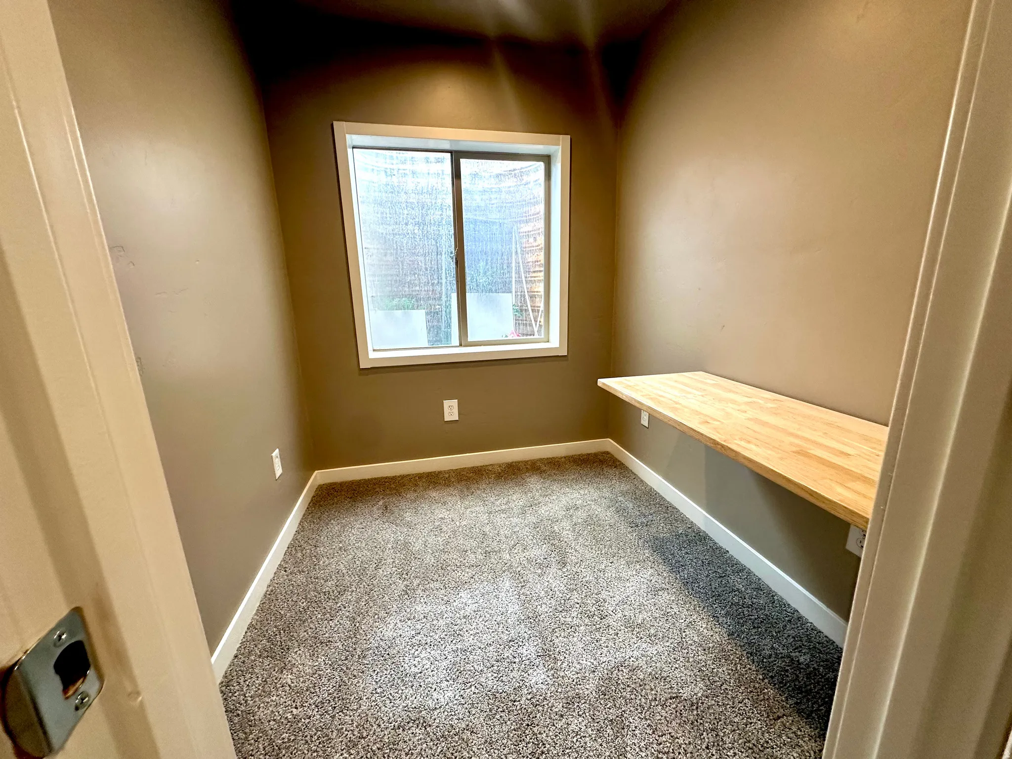 Unfurnished office with light carpet and baseboards