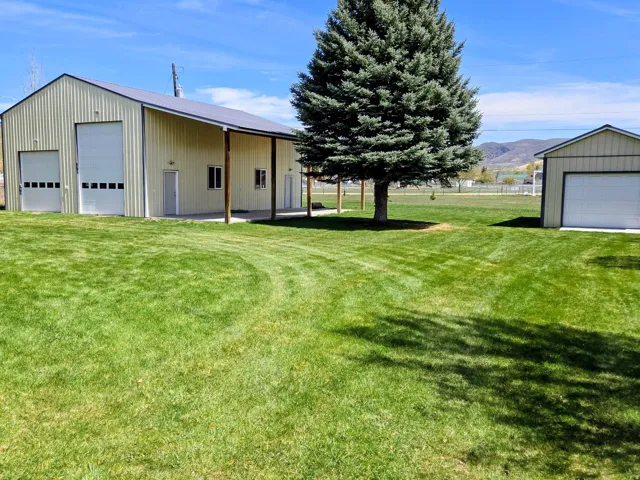View of yard featuring an outbuilding, a detached garage, and a mountain view