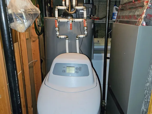 Utility room featuring heating unit and water heater