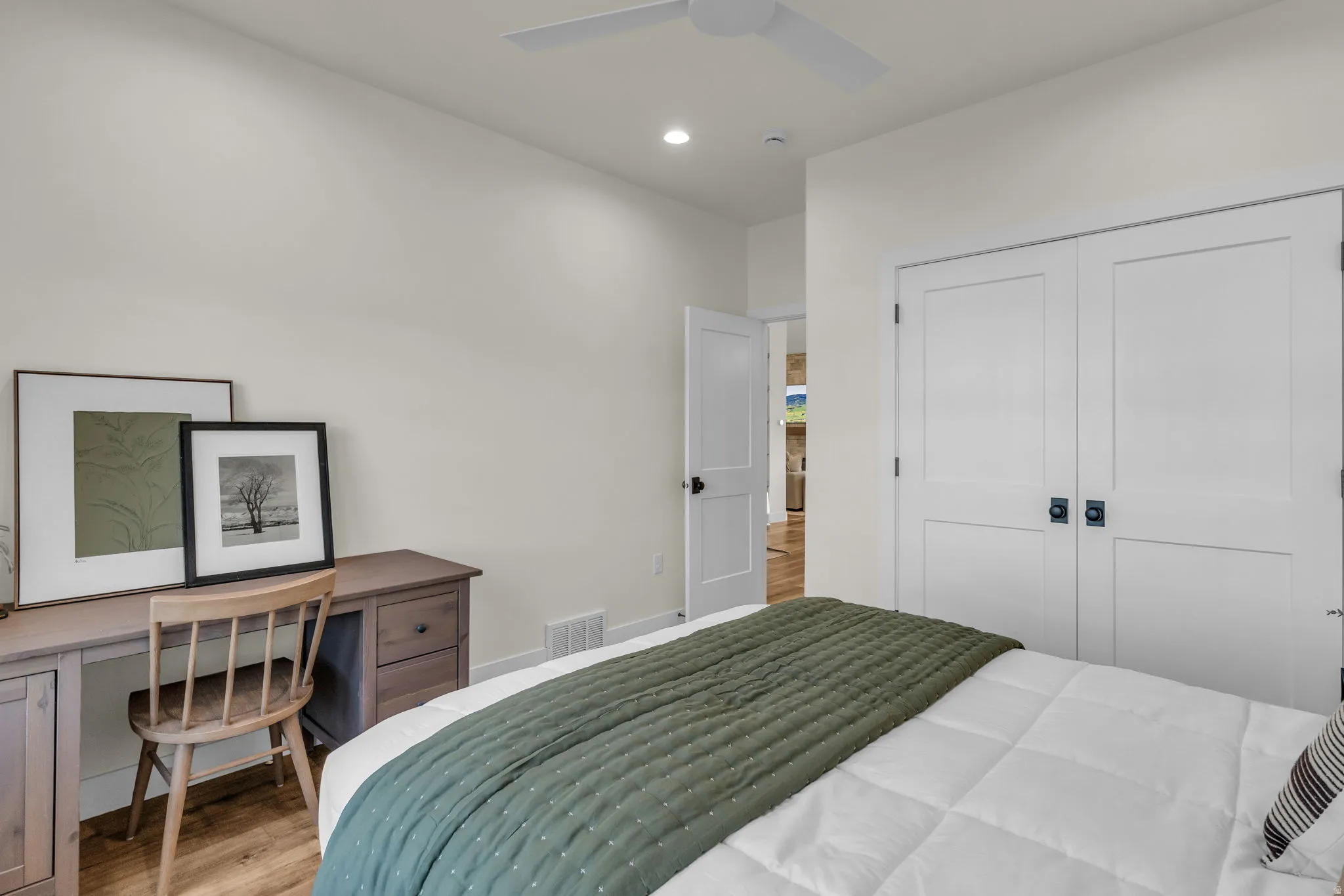 Bedroom featuring light wood-type flooring, a closet, a ceiling fan, and recessed lighting