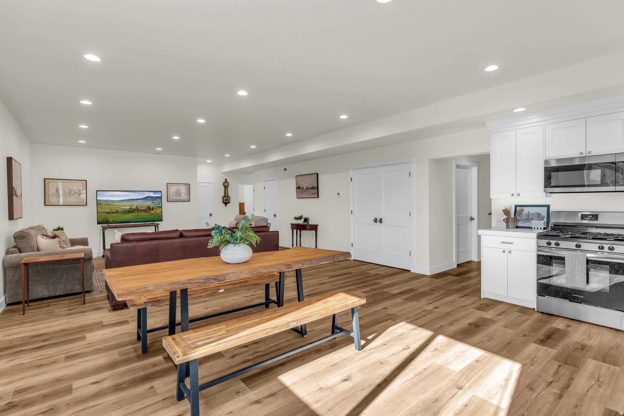 Dining area with recessed lighting and light wood finished floors
