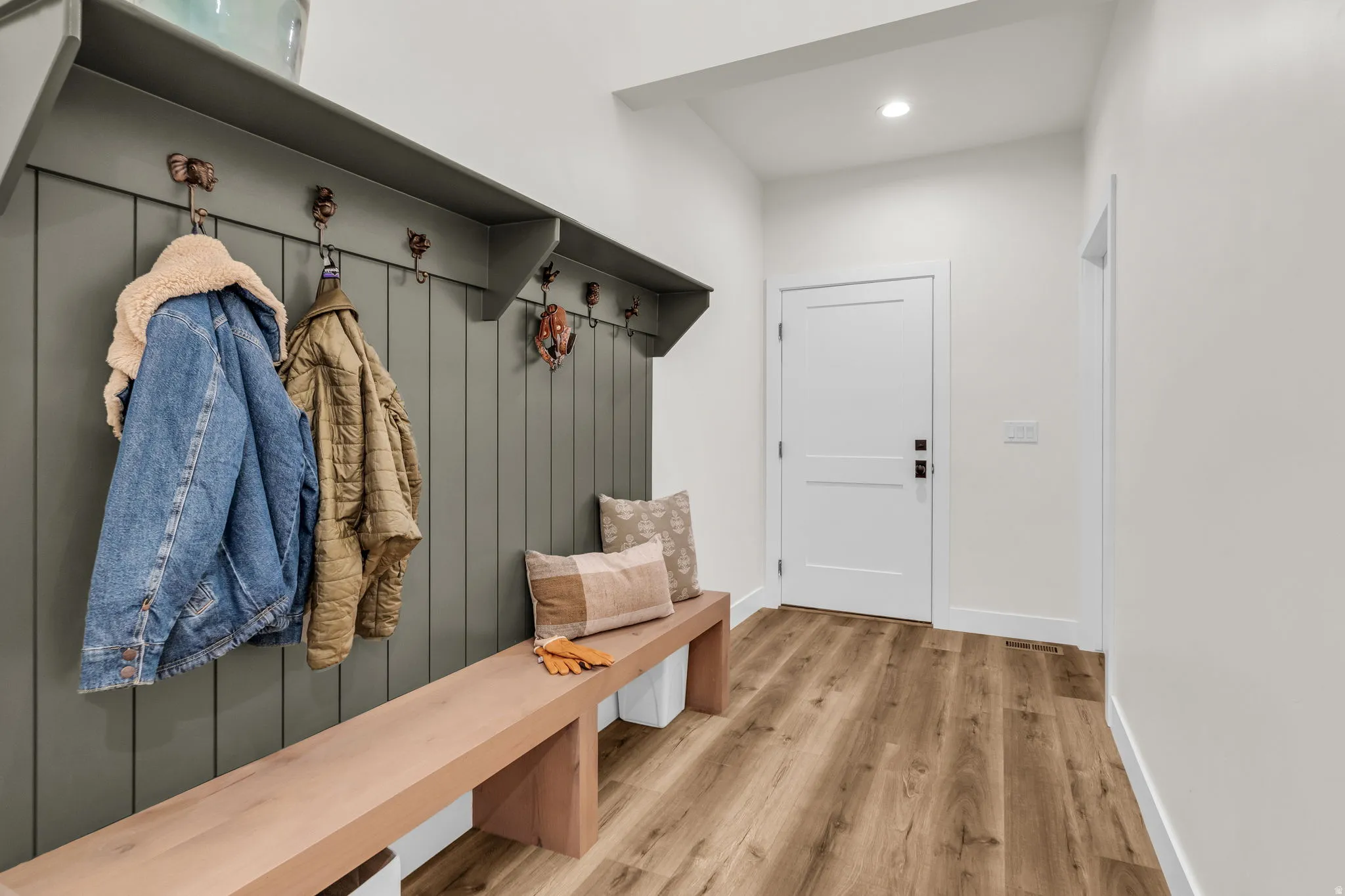 Mudroom with light wood-type flooring and recessed lighting