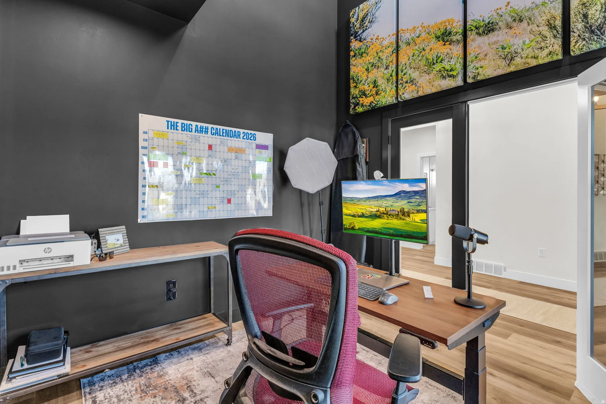 Office area featuring wood finished floors and a high ceiling