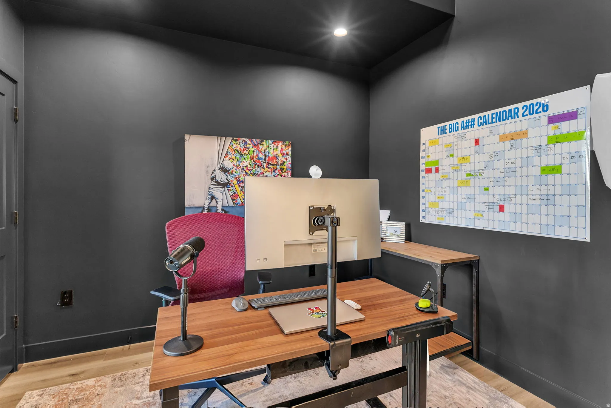 Office space with light wood finished floors and recessed lighting