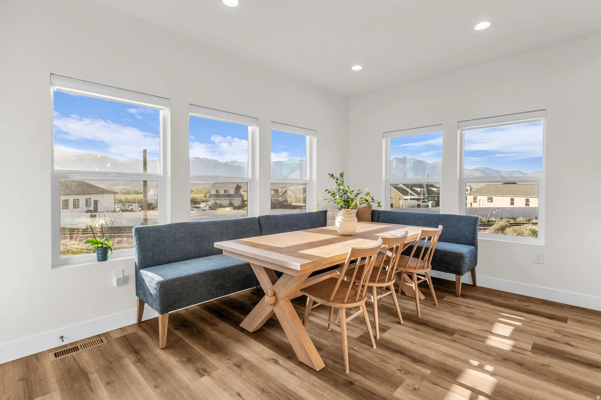 Dining area featuring light wood-style floors, plenty of natural light, and recessed lighting