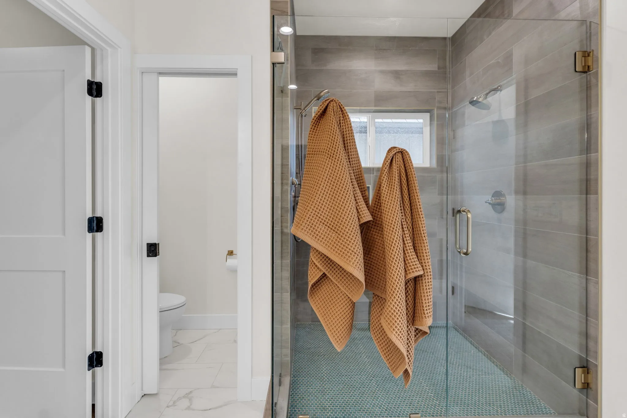 Bathroom with toilet and a stall shower