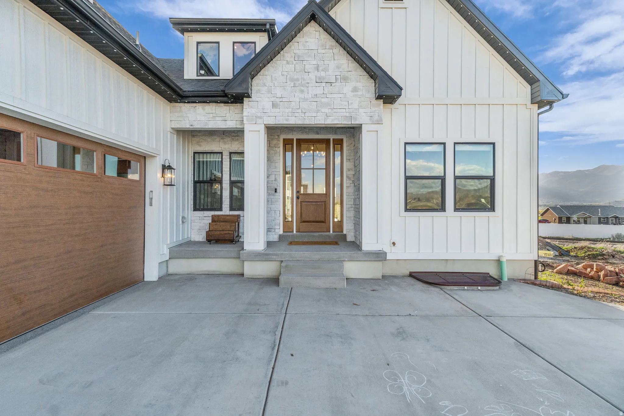 Property entrance featuring board and batten siding and stone siding