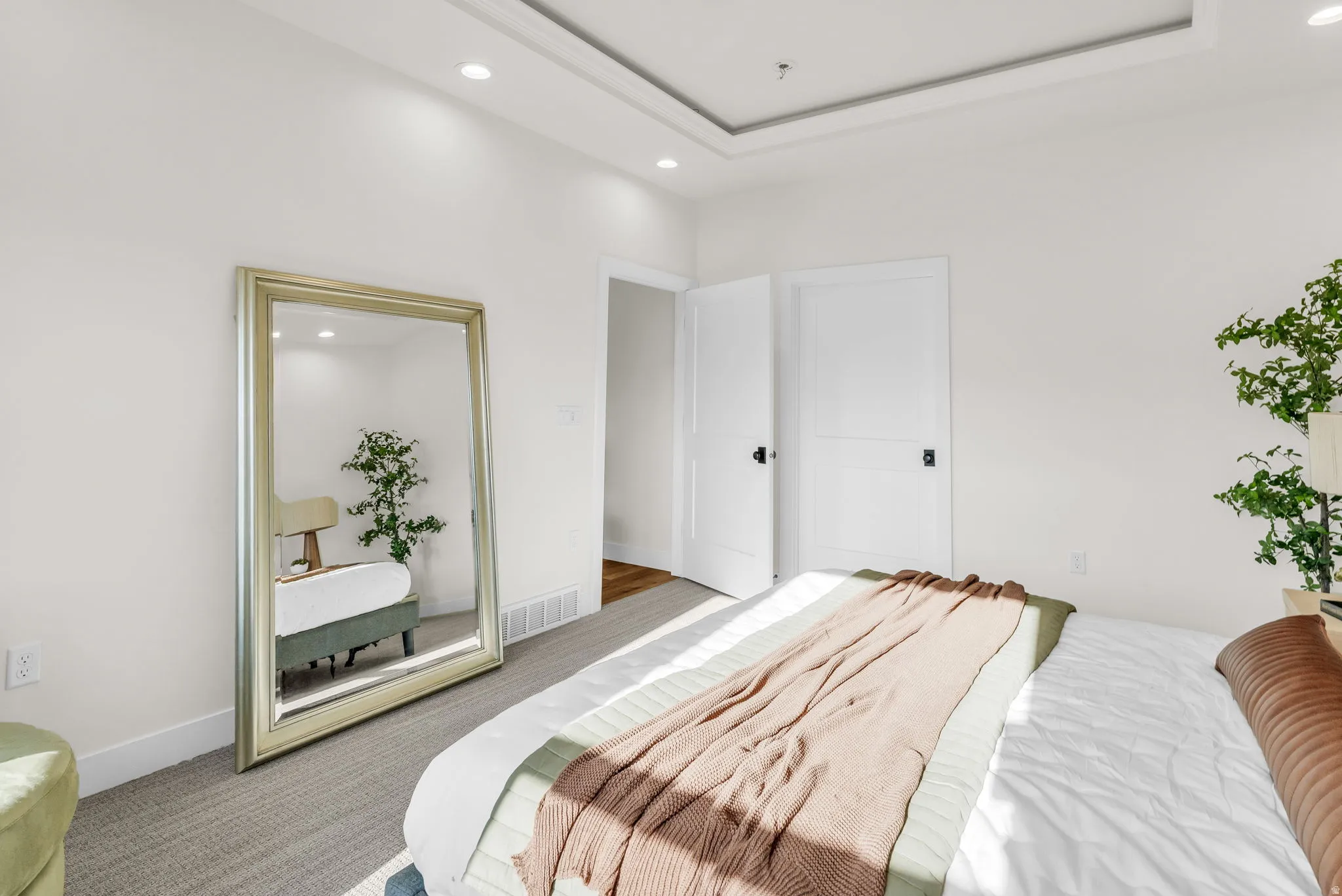 Bedroom featuring carpet flooring, recessed lighting, and a tray ceiling