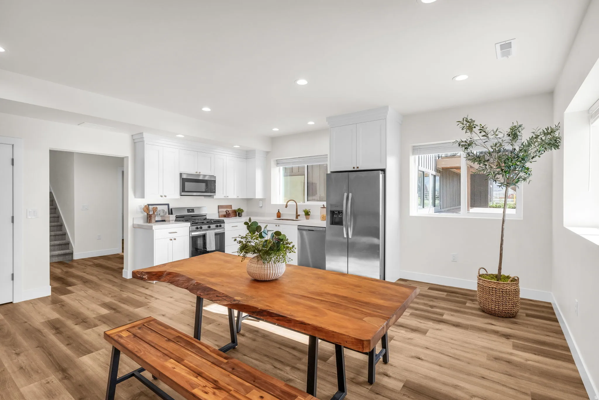 Dining area with light wood-style flooring and recessed lighting