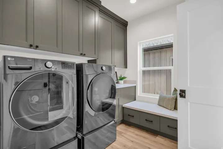 Laundry room featuring washer and clothes dryer, light wood-style flooring, cabinet space, and recessed lighting