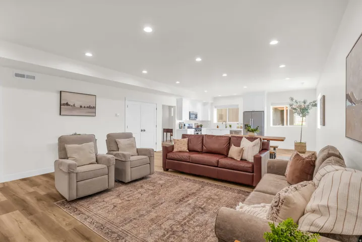 Living room with recessed lighting and light wood-style flooring
