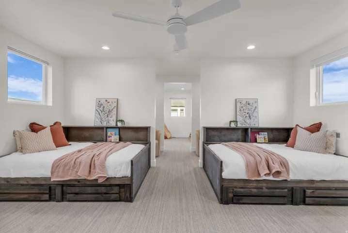 Carpeted bedroom featuring a ceiling fan and recessed lighting