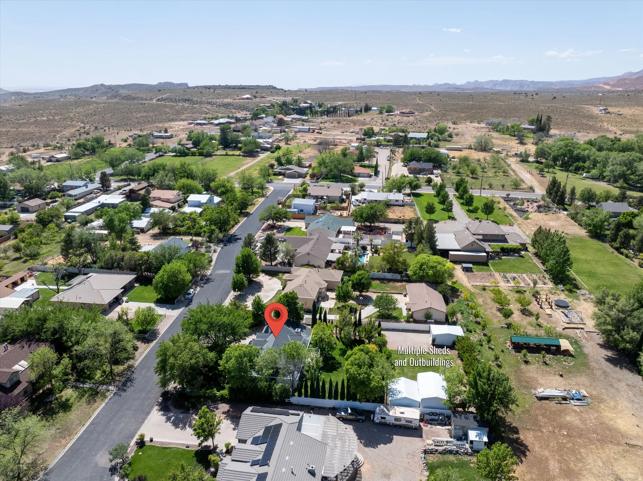 Aerial overview of property's location with a mountainous background and nearby suburban area