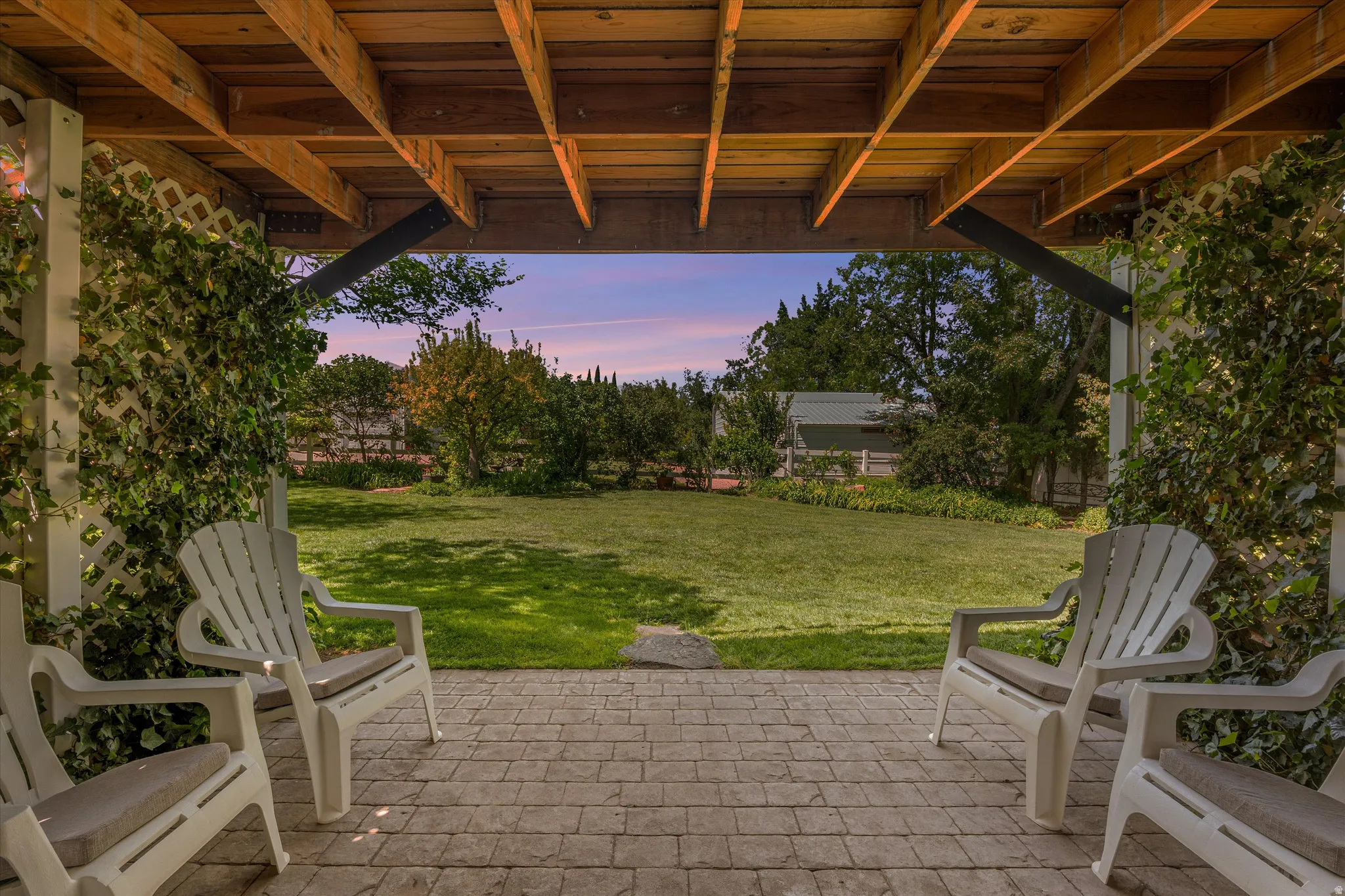 Patio terrace at dusk with a yard and a patio area