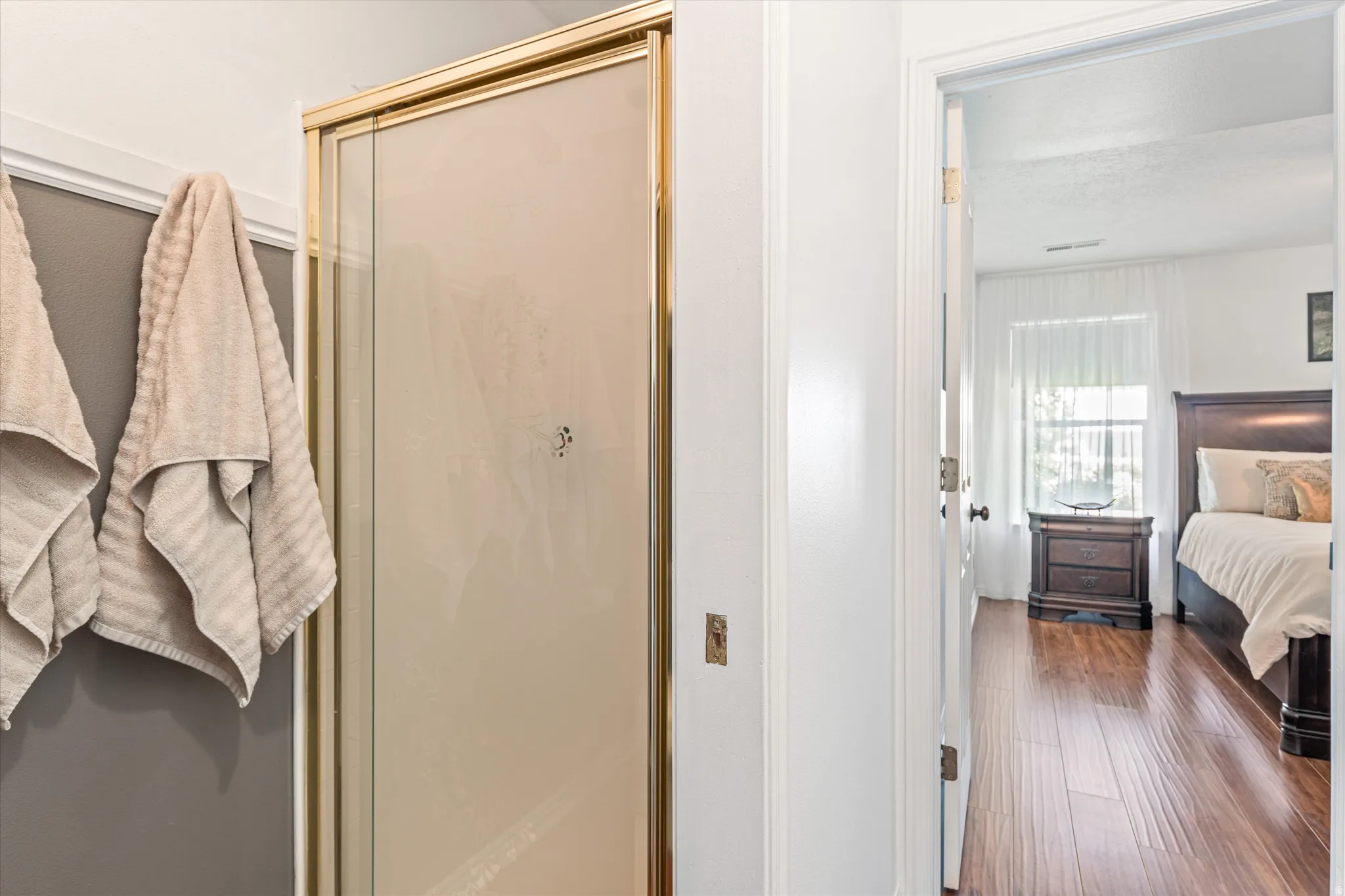 Bedroom with dark wood finished floors and a closet