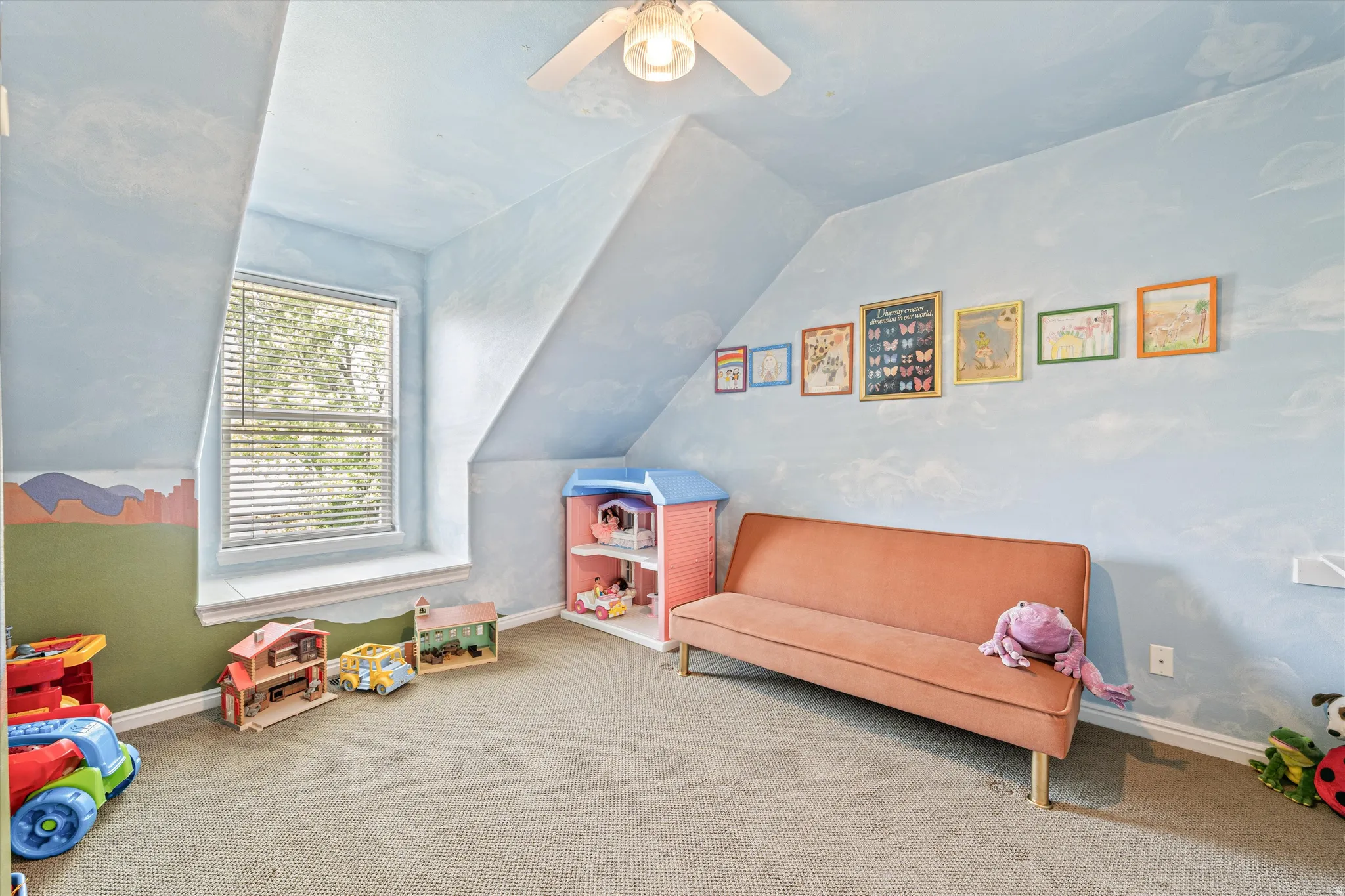 Recreation room featuring vaulted ceiling, carpet, and a ceiling fan